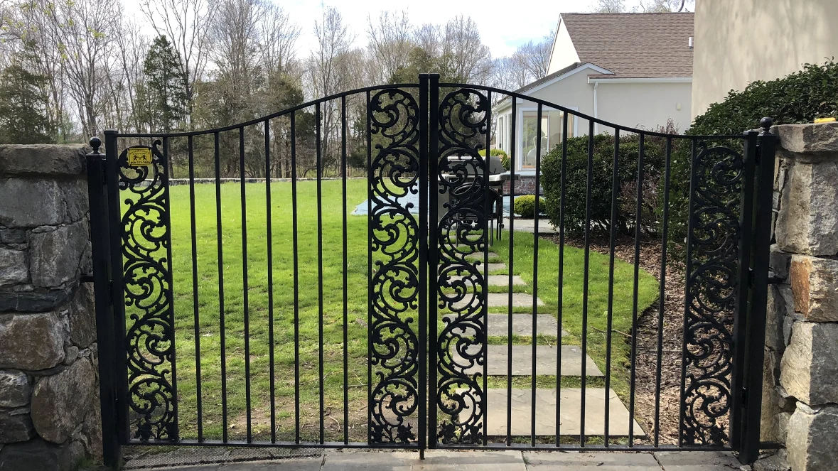 Decorative black iron walk gate with detailed side panels