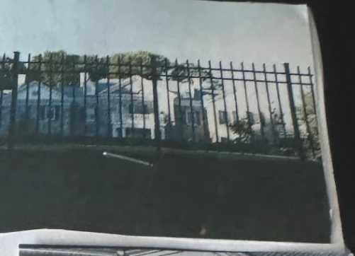 Tall iron perimeter fence protecting a commercial property