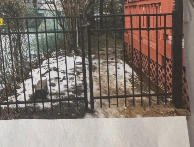 Tall black security fence installed beside a commercial property