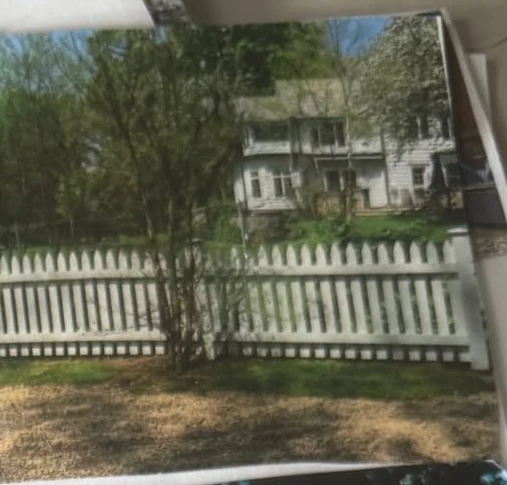 Long white picket fence across a residential estate