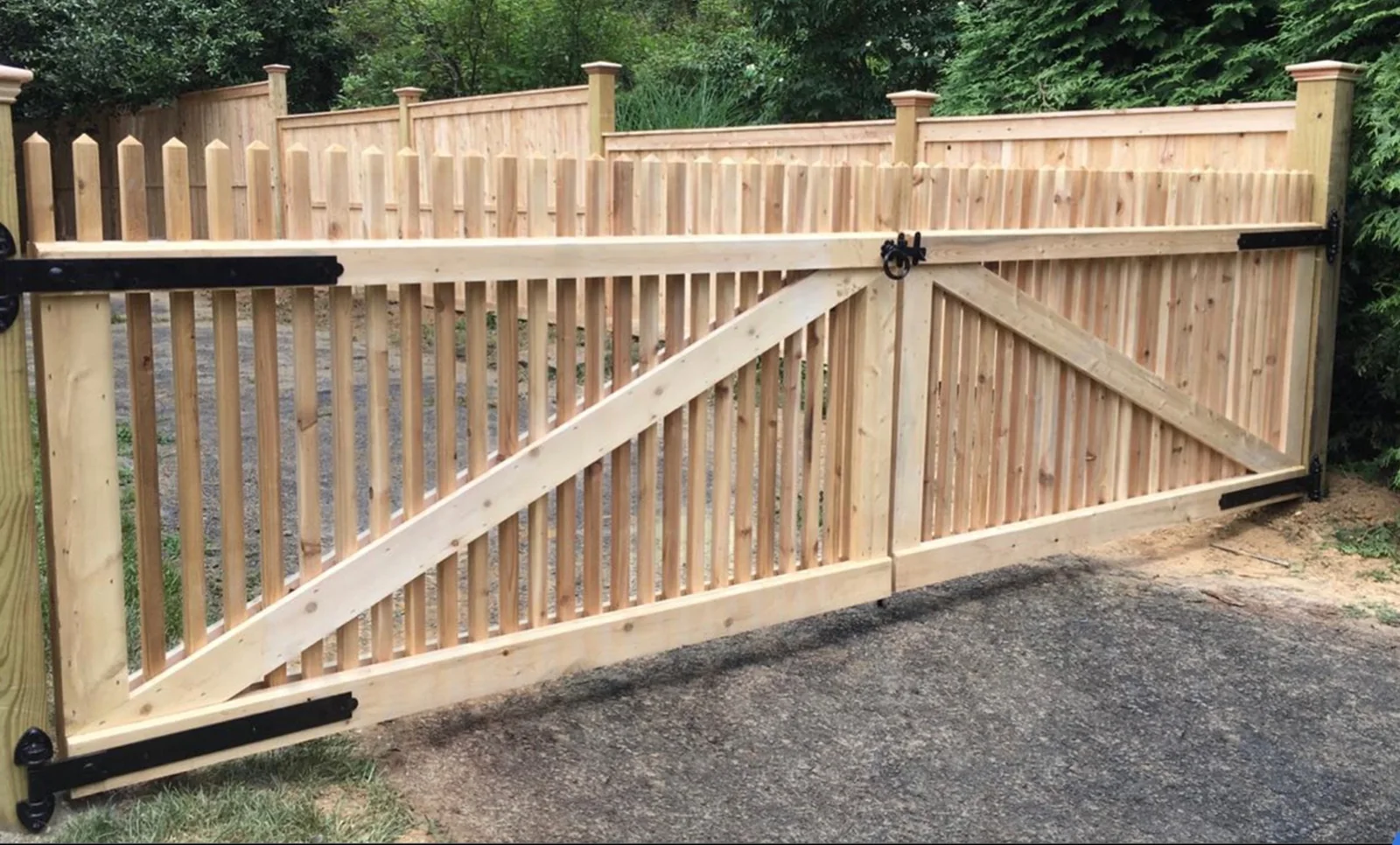 Custom cedar double driveway gate and matching privacy fence