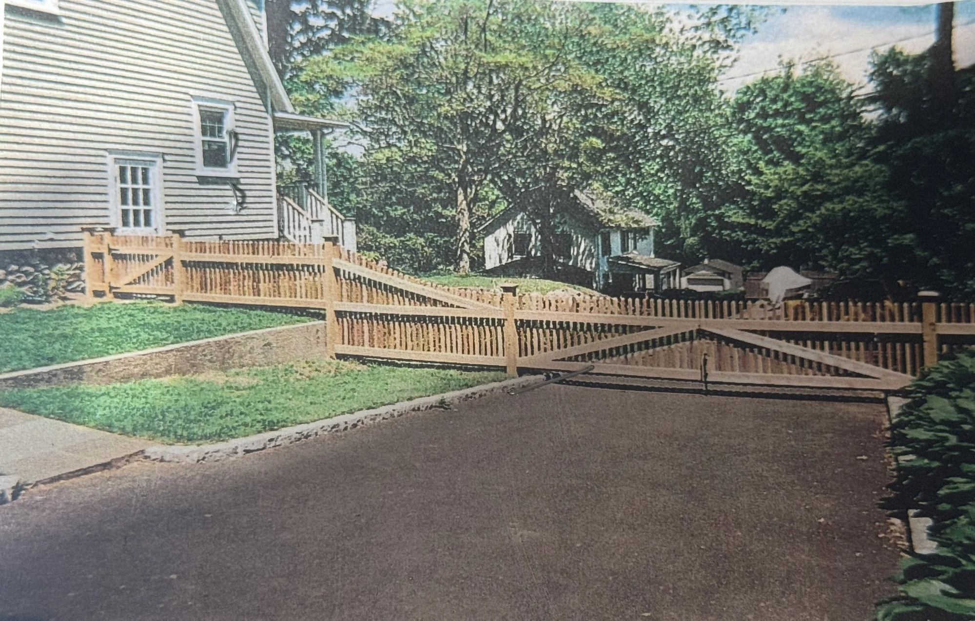 Wide cedar driveway gate and matching fence