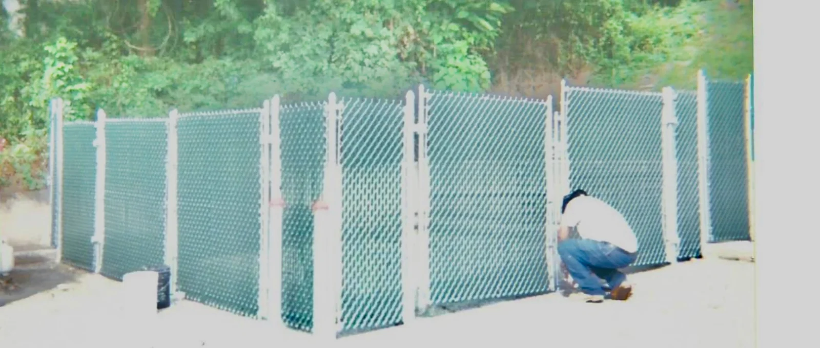 Green Vinyl-Coated Chain Link Enclosure project by Excalibur Fence and Iron Works